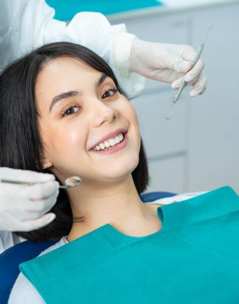 Smiling dental patient undergoing exam