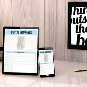 Dental insurance forms on tablet on desk