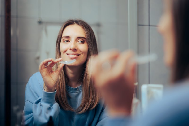 Patient putting in their Invisalign aligner